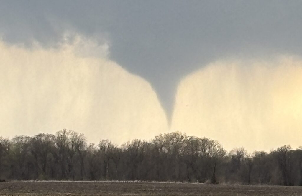 Funnel cloud over a field.